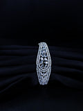Silver bracelet with intricate design on a black background